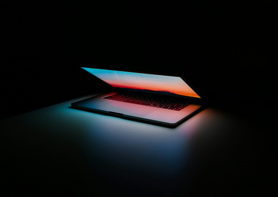Laptop glowing in a dark studio